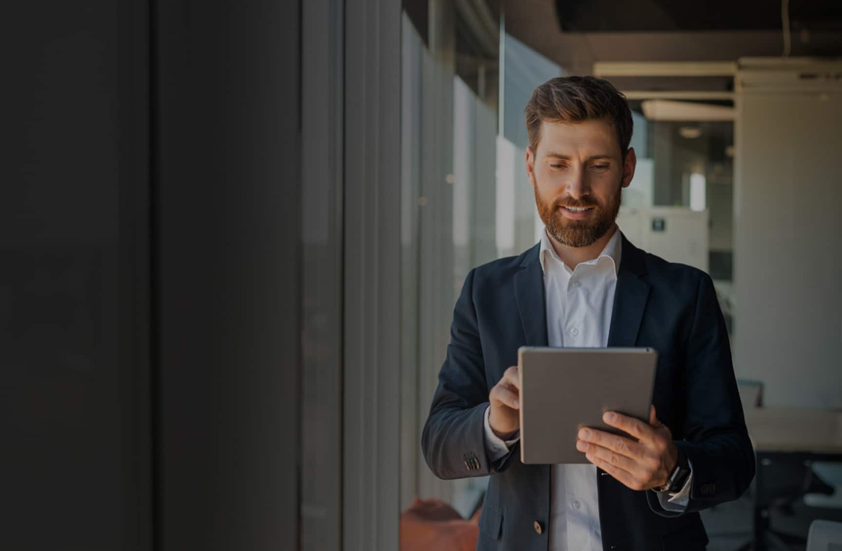 Background photo of man holding a tablet device